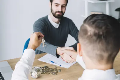 client-shaking-hand-agent-looking-keys-min Loan service