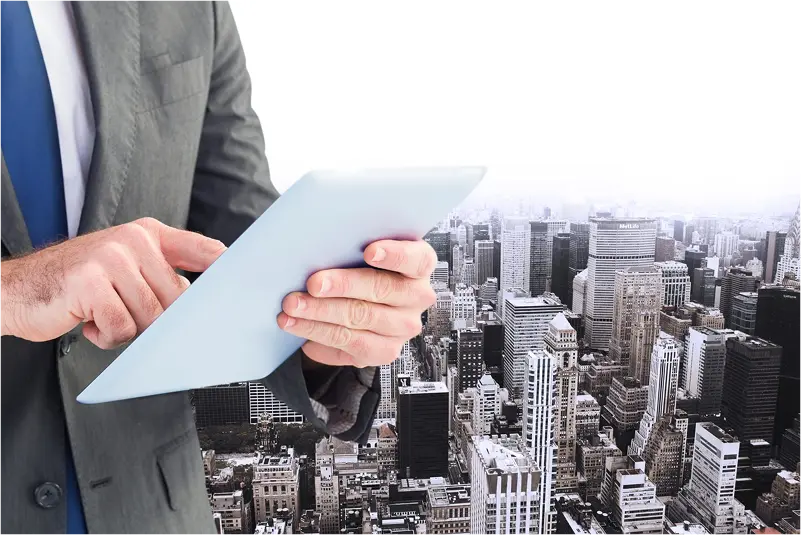 executive-with-tablet-buildings-background-min About us page Image